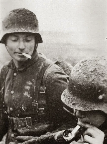 6_German_Soldier_Lights_His_Cigarette_wi