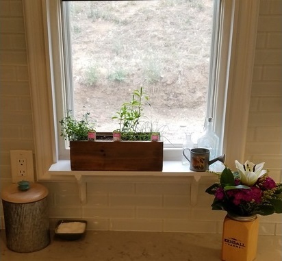 Another customer used the same rectangular planter box to grow a few herbs right on their kitchen window